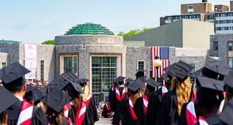 Image of graduates walking to the ceremony site.